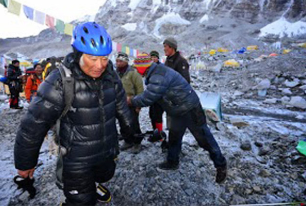 Japanese adventurer Yuichiro Miura leaves the base camp at 5,300 meters (17,388 feet) for his attempt to scale the summit of Mount Everest. - AP Photo/Miura Dolphins