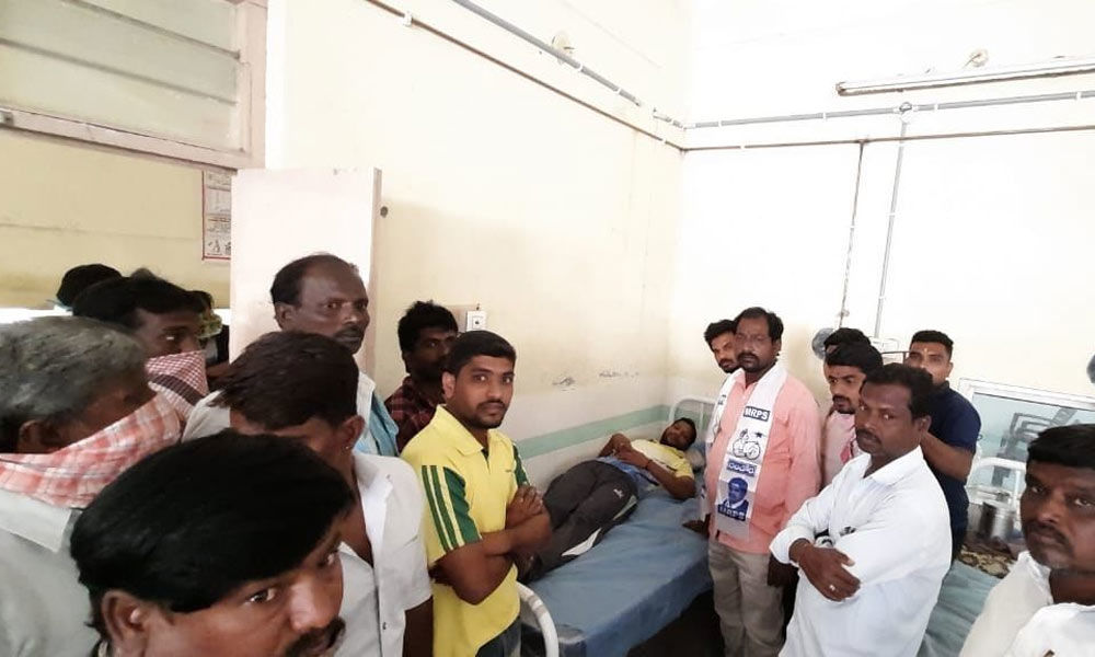 The MRPS leaders consoling the injured PET teacher Kodi Eeranna being treated at Adoni Government General Hospital