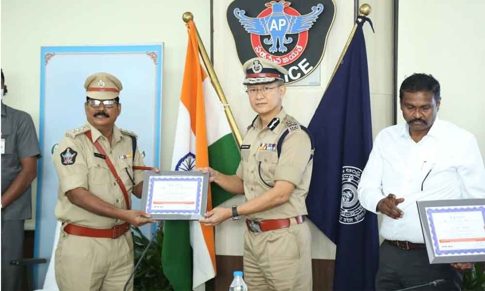 Police personnel receiving awards from DGP Gautam Sawang at State Police Headquarters, Managalagiri in Guntur